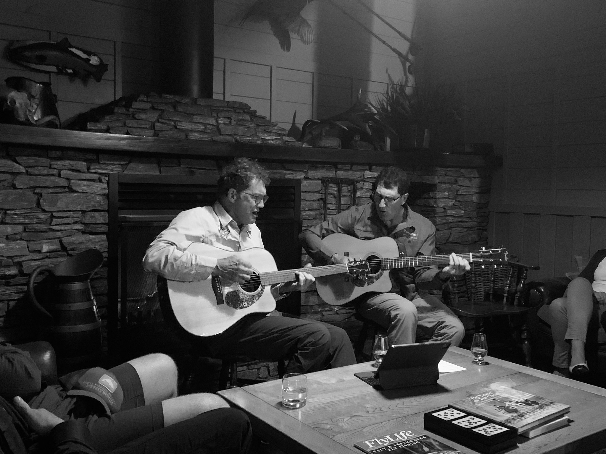 two men playing guitar in poronui lodge