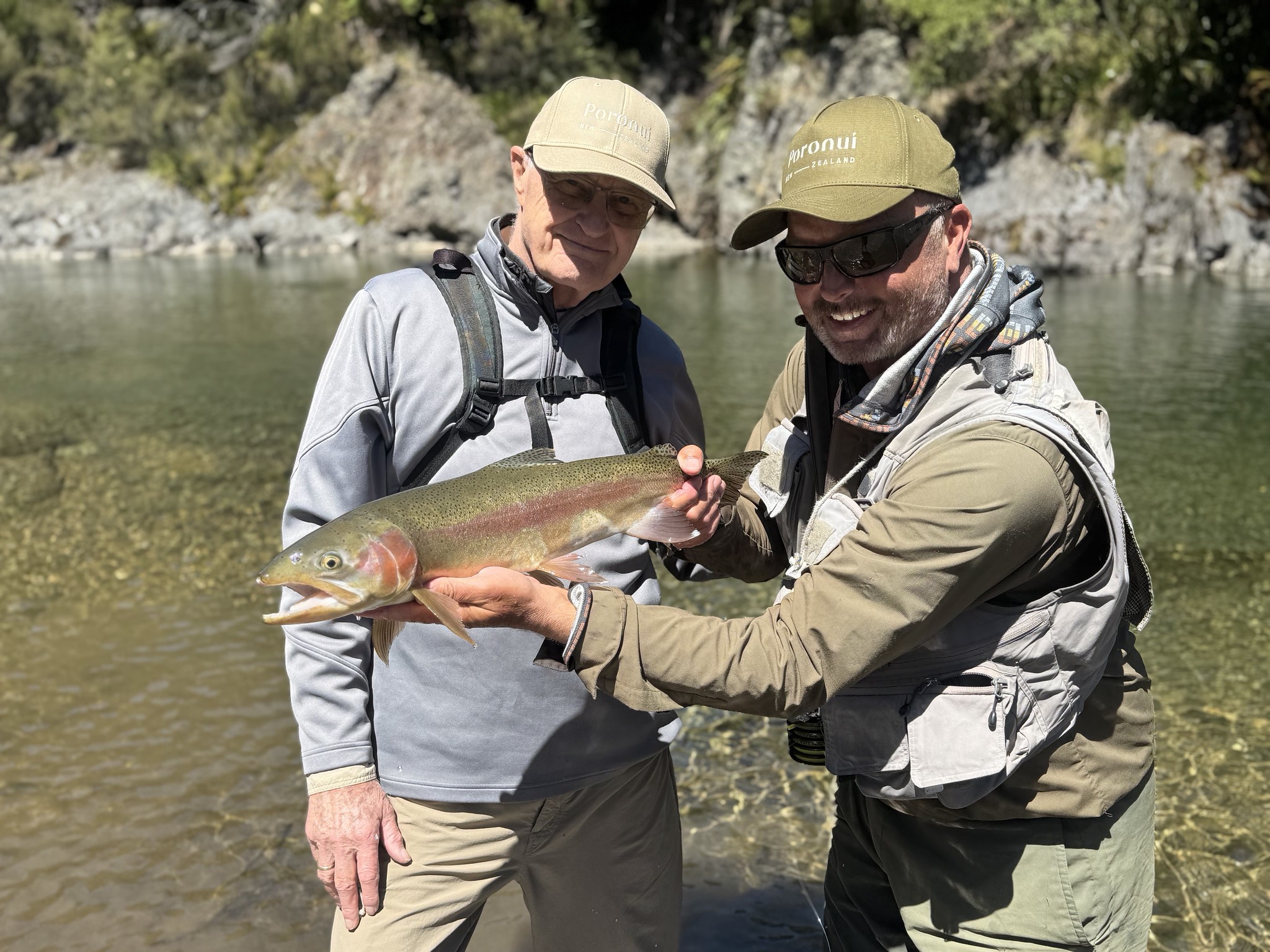 two happy guys with their trout fish